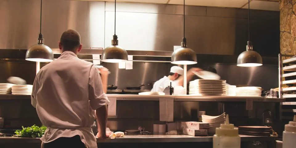 Chefs at work in a busy restaurant kitchen