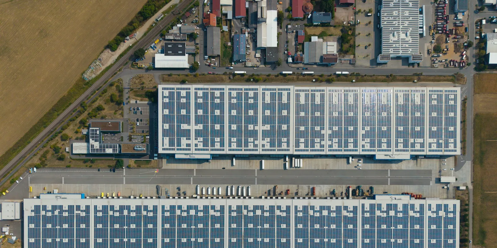 Aerial view of large distribution centres with lorries at the loading bays